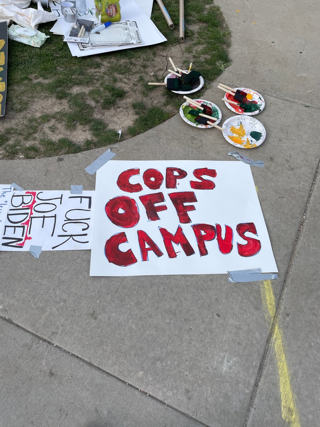 A sign saying "cops off campus" in red paint